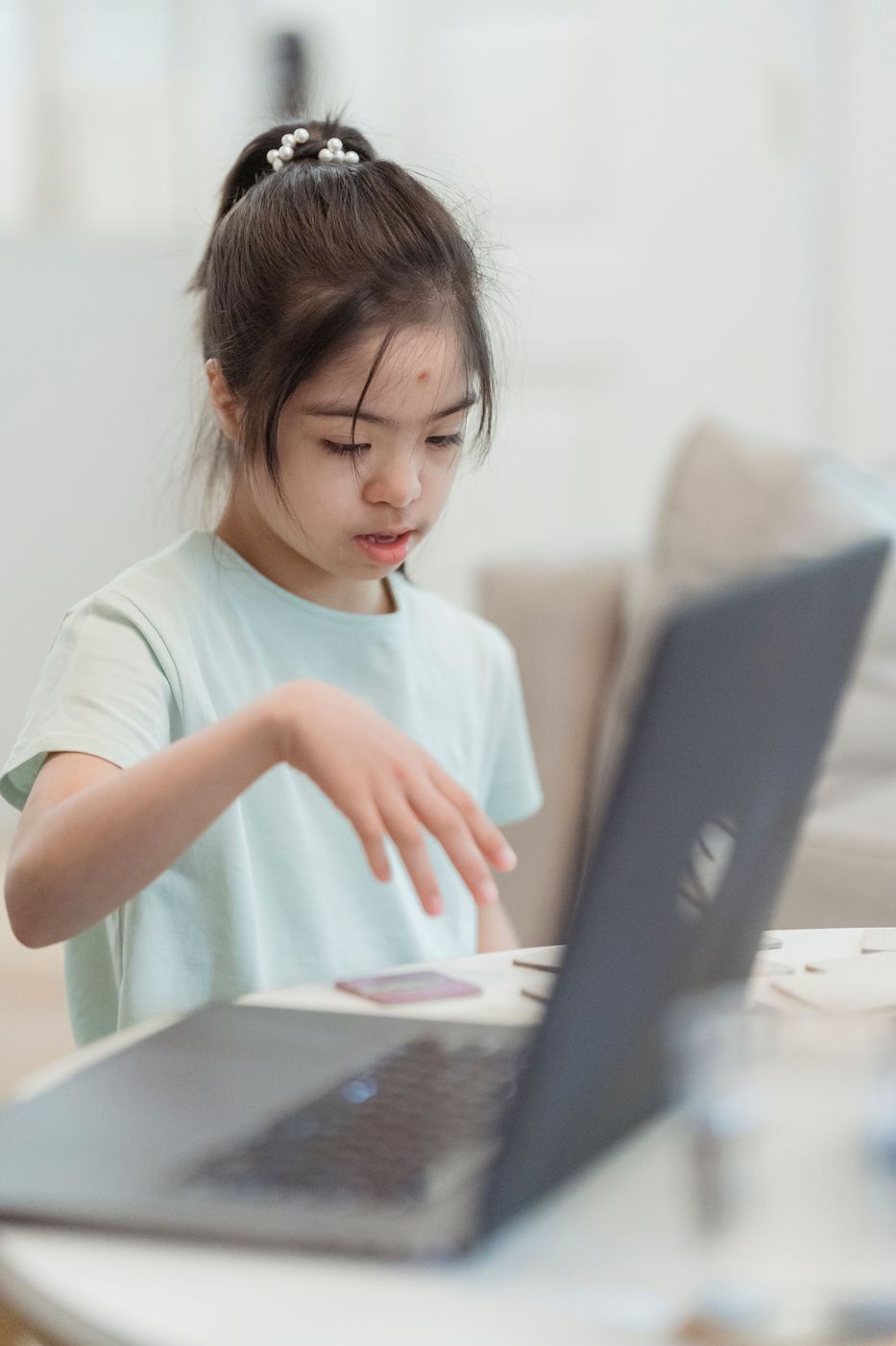 Young child following an online lesson on a laptop